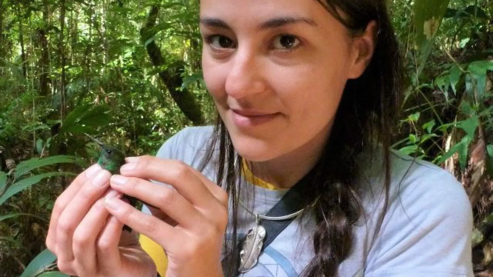 Joanna Kingsbury holding a bird in the field