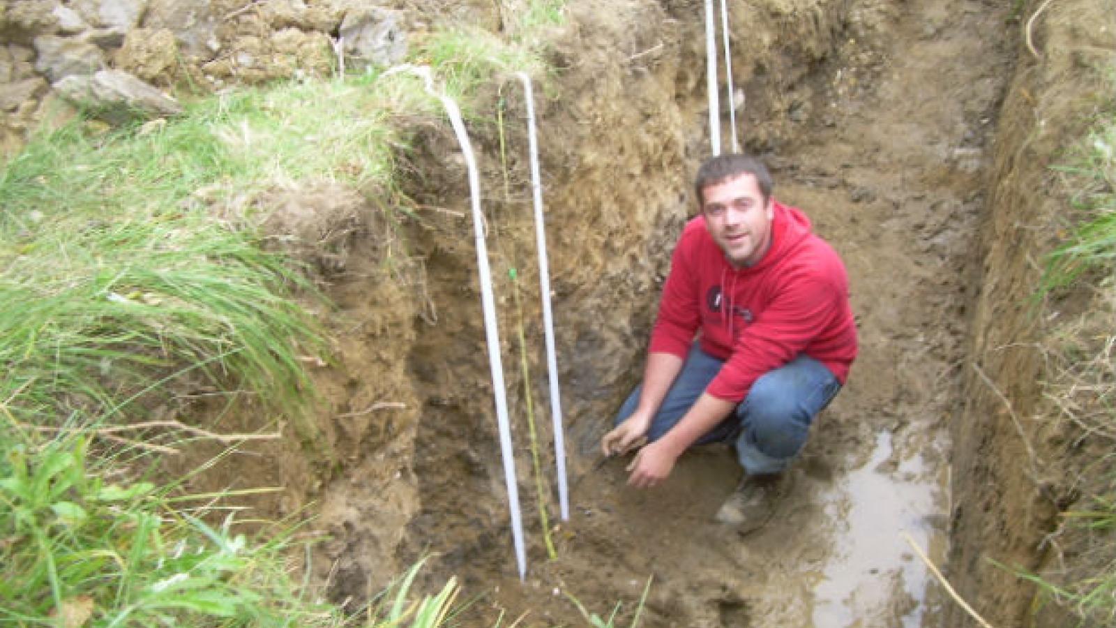 student examines a soil profile